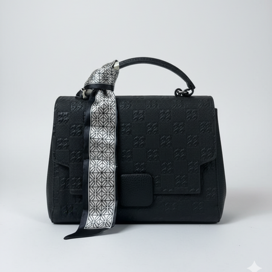 Black textured handbag with a patterned strap on a white background