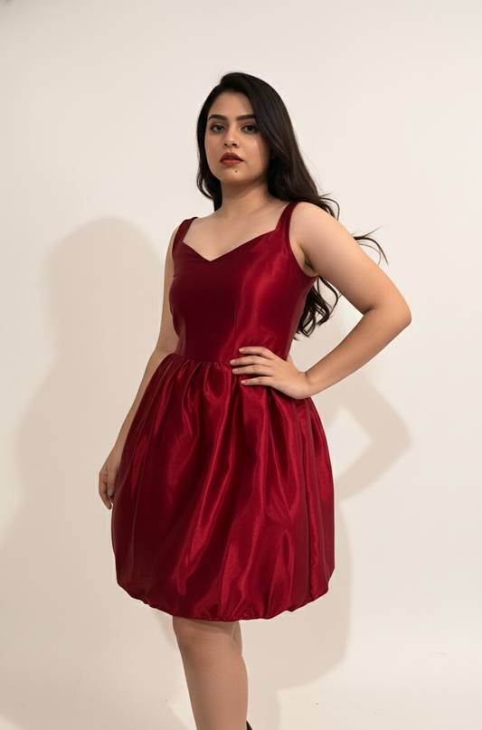 Woman wearing a red dress against a plain background