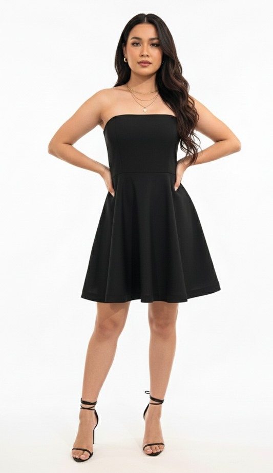 Woman wearing a black strapless dress on a white background