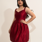 Woman wearing a red dress against a plain background