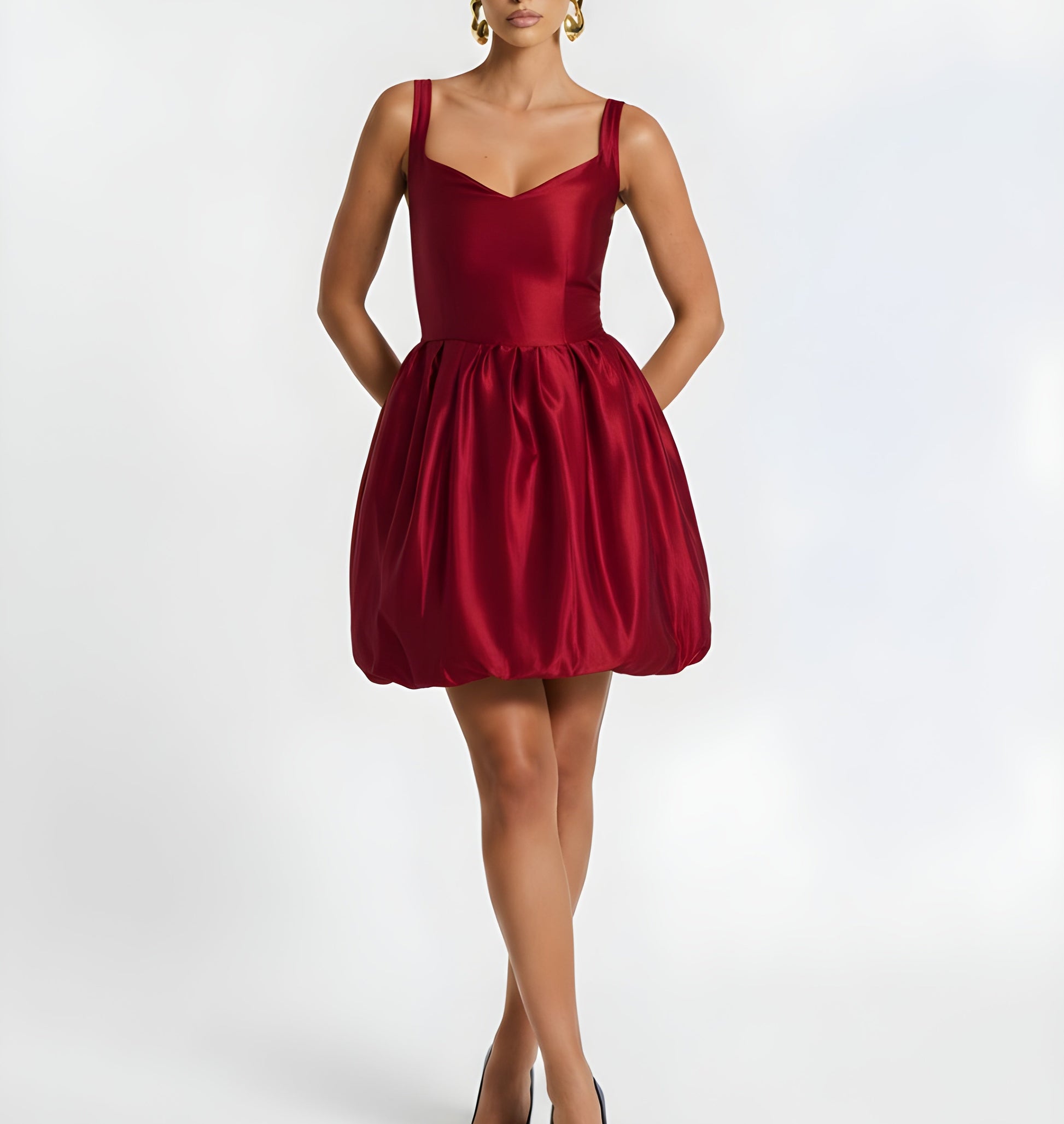 Red dress worn by a model on a white background