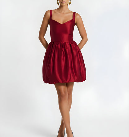 Red dress worn by a model on a white background